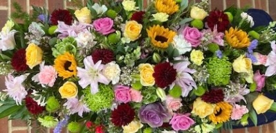 Florist choice Rainbow coffin spray